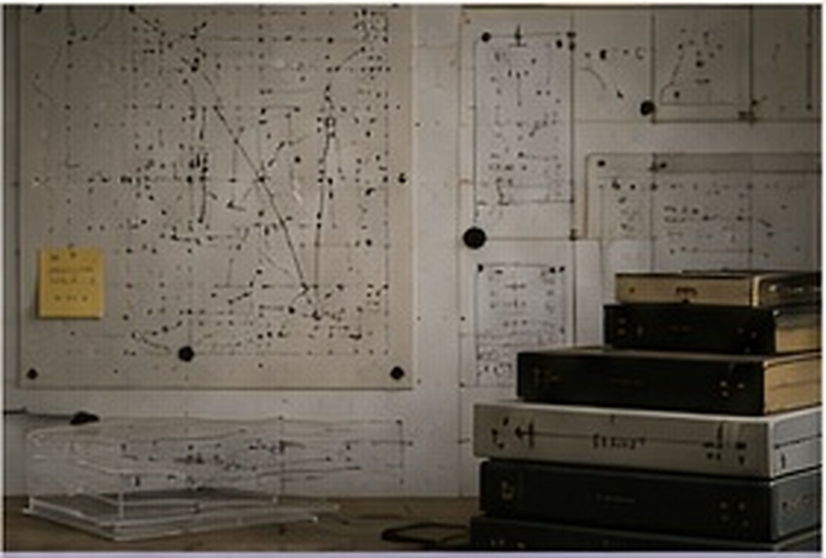 Research wall with diagrams, folders and translucent materials